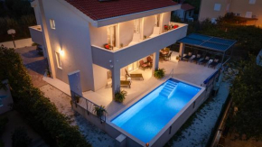 Villa Leonore in Omis with 4 en-suite bedrooms, heated pool, PS5, completely fenced yard & just 3 min walk from sandy beach